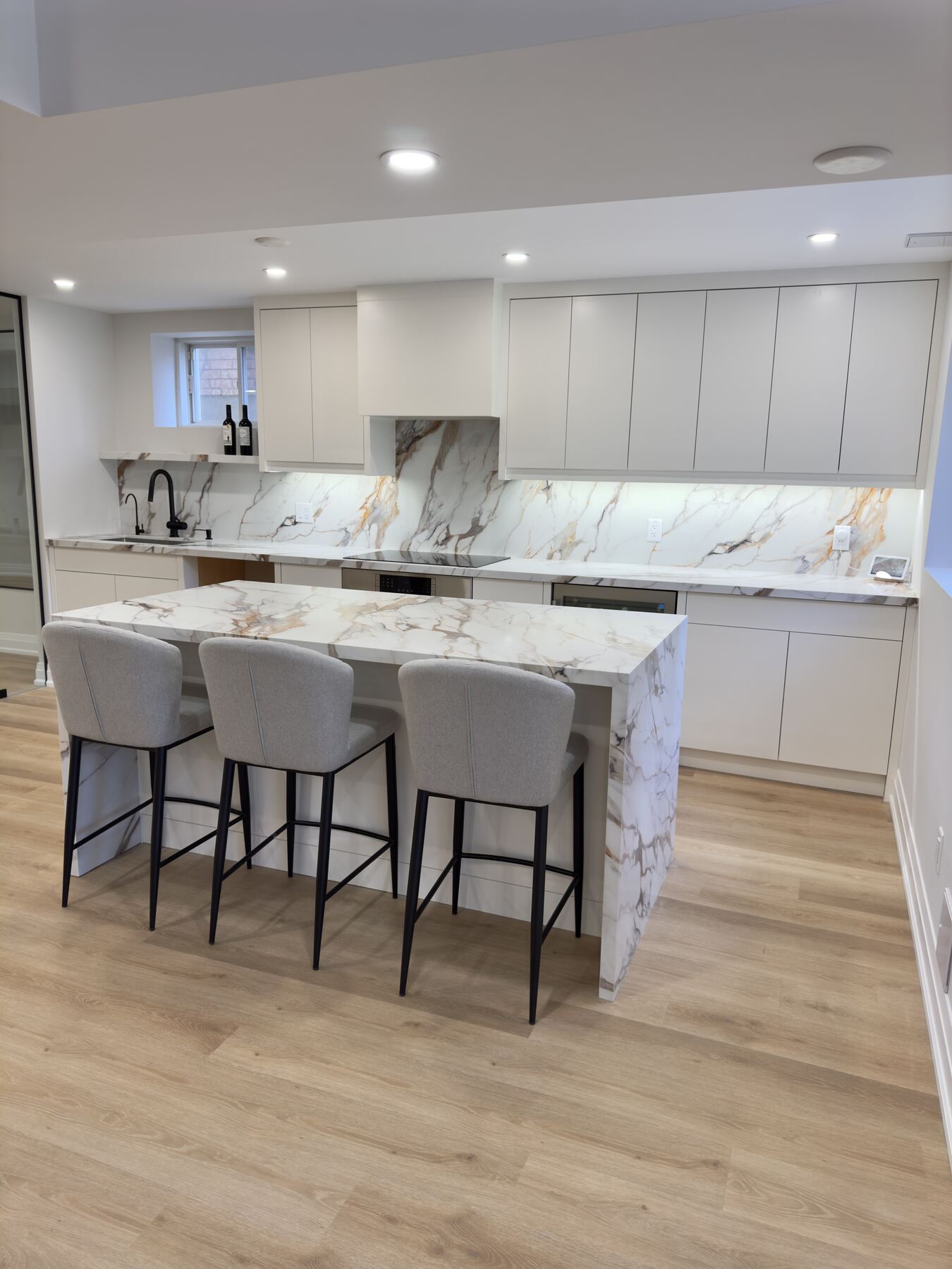 Custom white kitchen with quartz island — kitchen renovation in the GTA by Desire Basements
