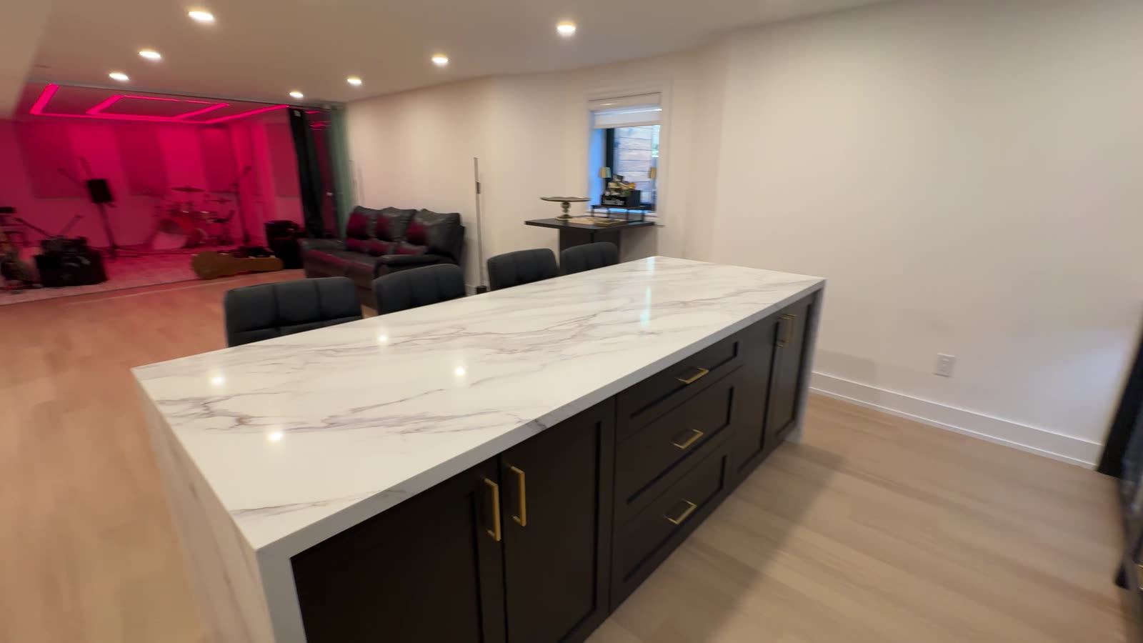 Finished basement bar with marble island and glass wine display — real Desire Basements project, Toronto